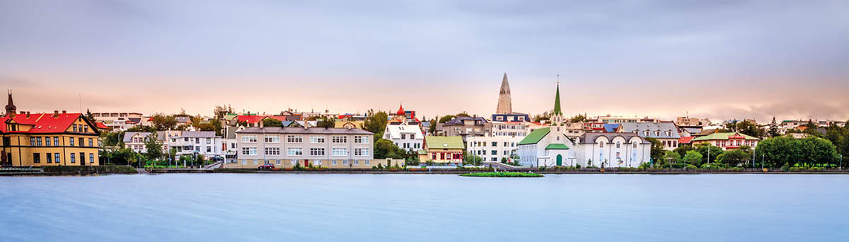 Long exposure image of Reykjavik skyline as viewed from Tjornin Lake in the center of the city