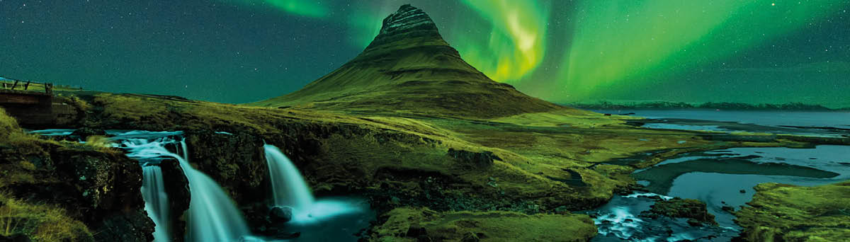 northern lights appear over Mount Kirkjufell with kirkjufellfoss waterfall in Iceland 