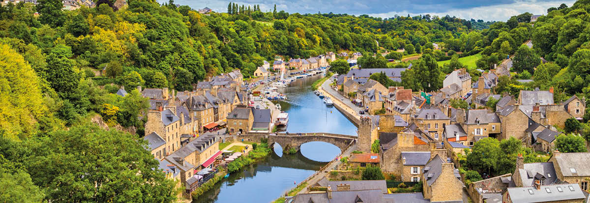 Aerial view of the historic town of Dinan with Rance river with dramatic cloudscape, Cotes-d'Armor department, Bretagne, northwestern France 