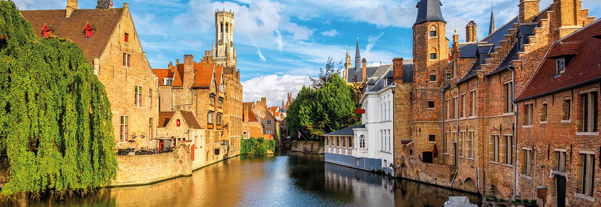 The Rozenhoedkaai canal, historical brick houses and the Belfry in Bruges medieval Old Town, Belgium, a UNESCO World Culture Heritage site