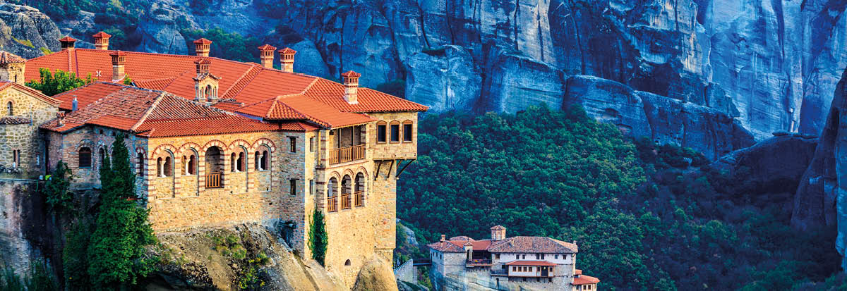 Holy Varlaam monastery on cliff in Meteora, Rousanou nunnery in the distance, Thessaly Greece  Greek destinations