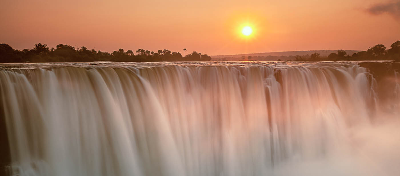 Sunrise breaks above Victoria Falls, Zimbabwe