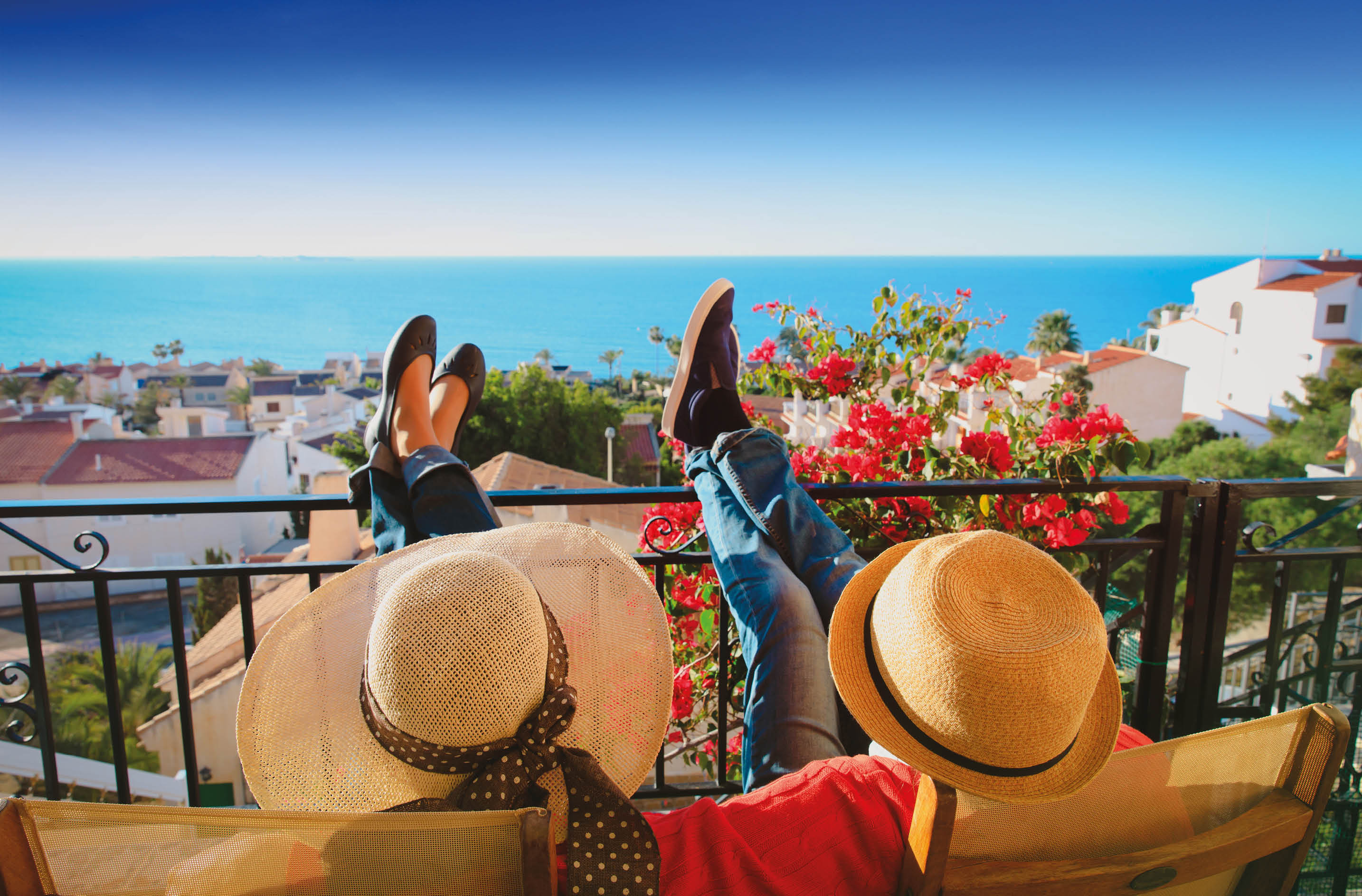 happy couple relax on balcony terrace, on vacation in Europe