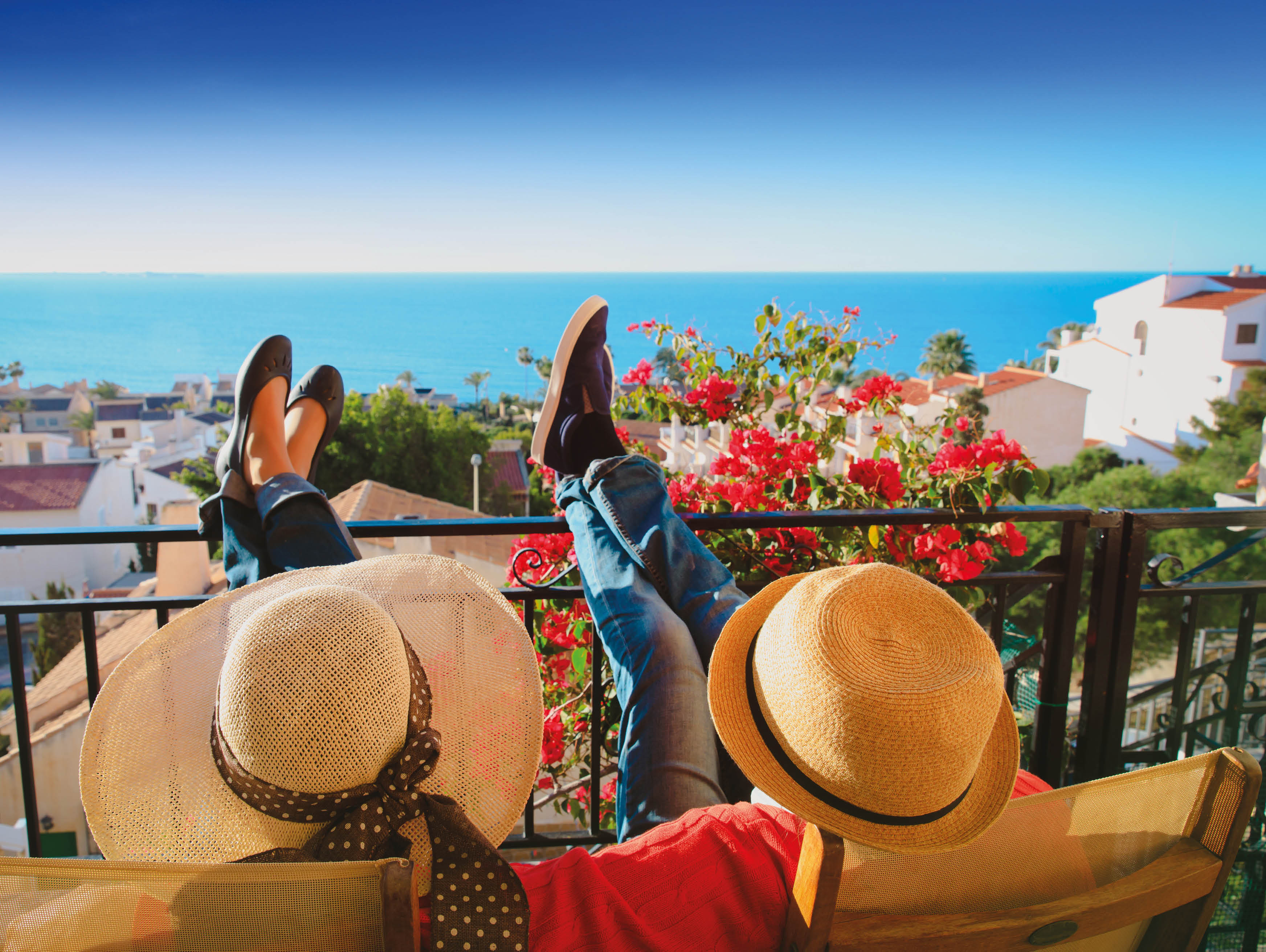 happy couple relax on balcony terrace, on vacation in Europe