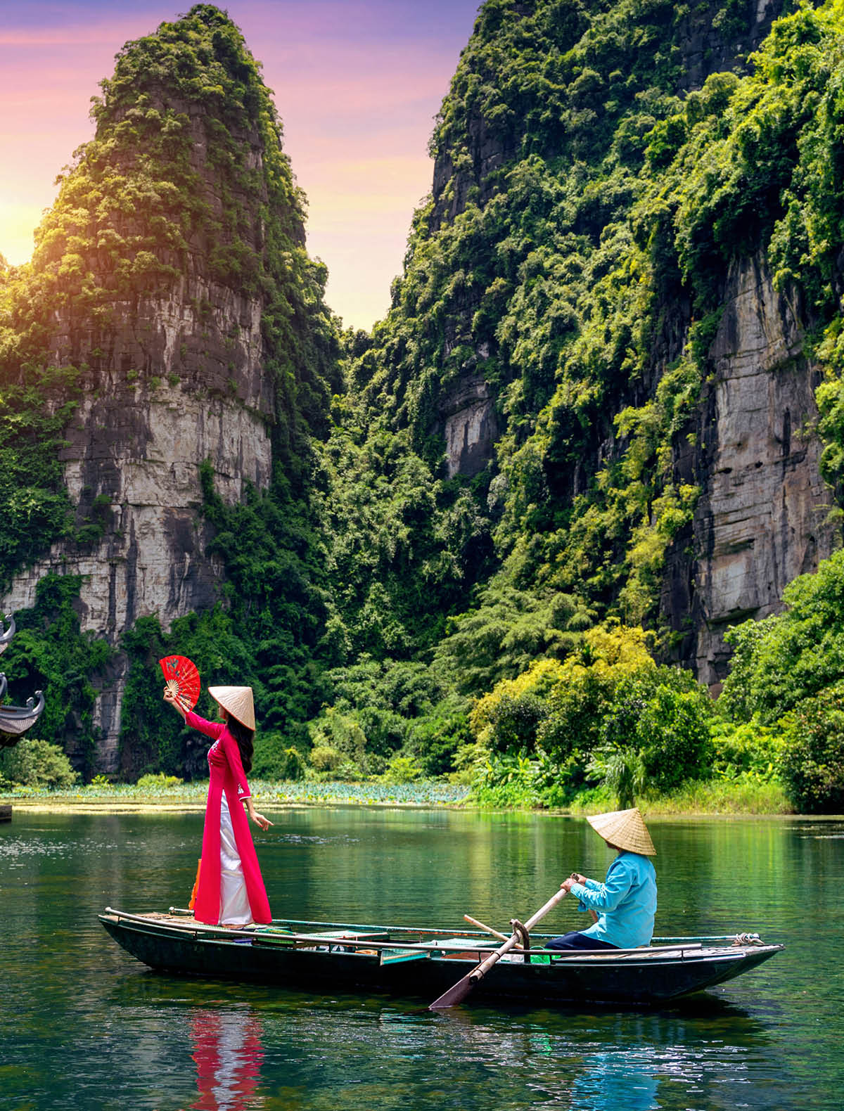 Asian woman wearing Vietnam culture traditional at Trang An, Vietnam.