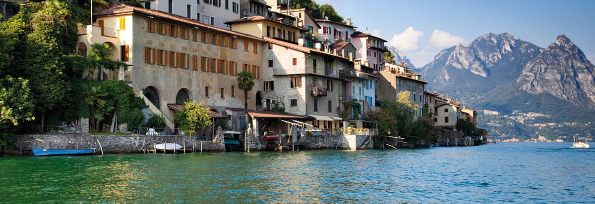 Lugano lake in Switzerland  View on shore with buildings 