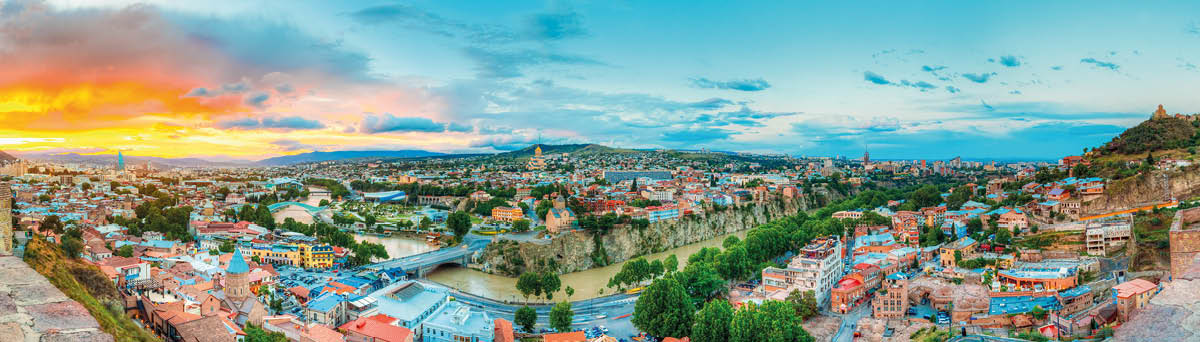 The Panoramic Top View Of  Motley Historic Part Of Tbilisi, Georgia In Summer  Skyline And Beautiful Sunset Sunrise On Picturesque Sky Background Over Central Part Of The City With Famous Landmarks 