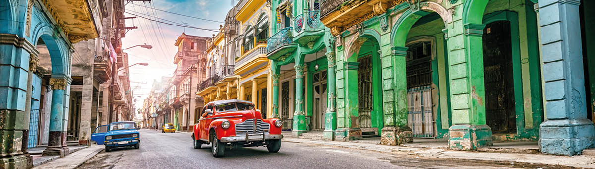 Vintage red oldtimer car driving through Havana Cuba