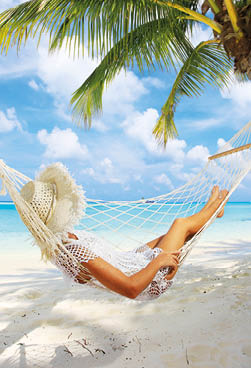 Woman relaxing in hammock near the azure sea 