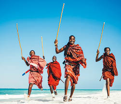 Masai warriors running on beautiful african beach, demonstrating their traditional hunting methods (zanzibar, Tanzania),