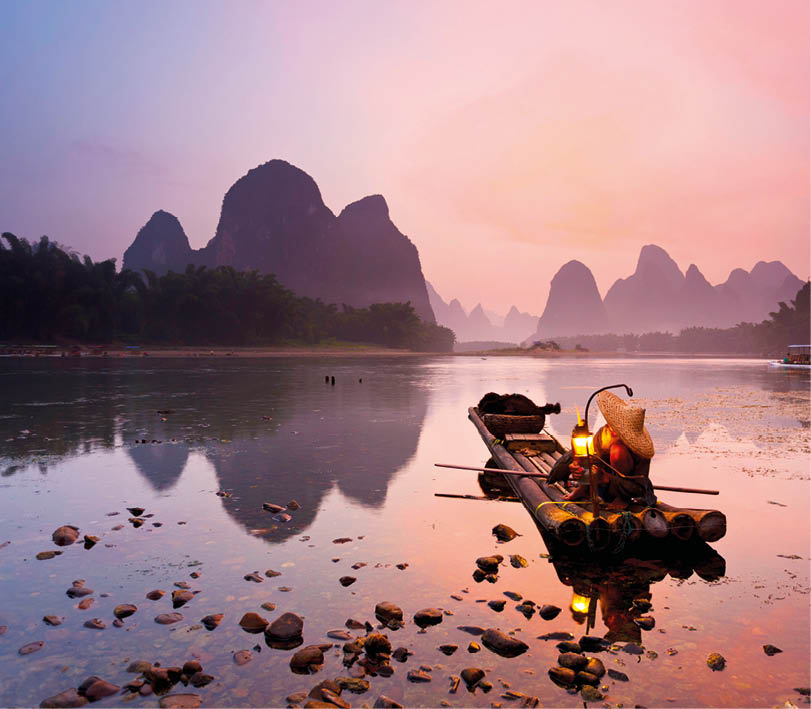 Cormorant fisherman getting ready for night fishing on the Li River, near Xingping Town, Guangxi province, China 