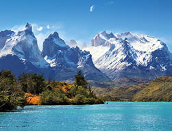 Azure Lake Pehoe at the foot of the magnificent snow-covered cliffs of Los Kuernos  National Park Torres del Paine, Chile